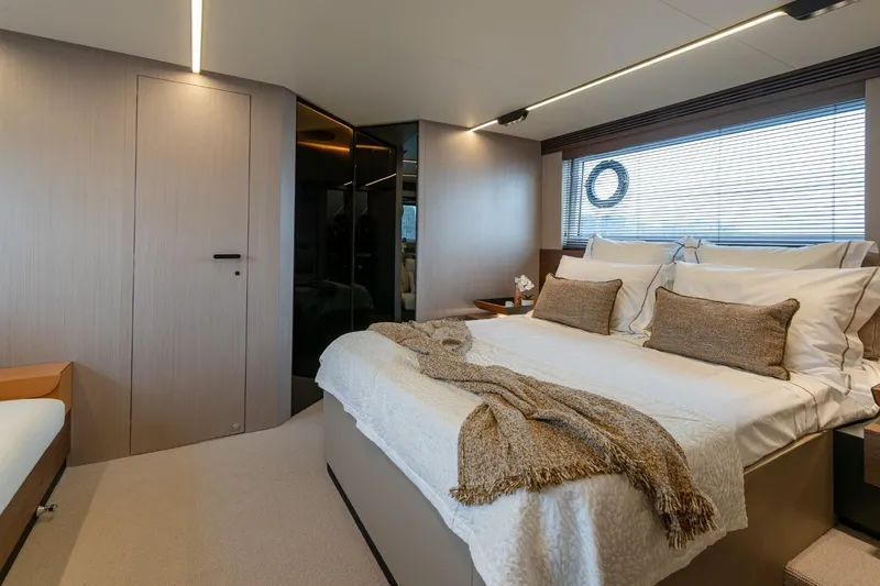  Yacht Photos Pics Luxurious bedroom interior of 2023 Azimut S7 yacht with modern design and cozy bedding.