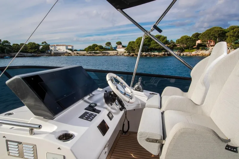  Yacht Photos Pics Cockpit of 2023 Azimut S7 yacht with modern controls and scenic ocean view.