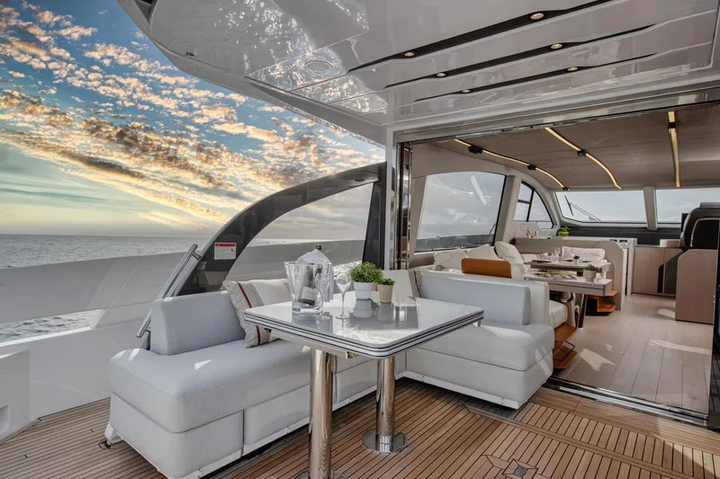  Yacht Photos Pics Luxurious 2023 Azimut S7 yacht interior with elegant seating and ocean view at sunset.