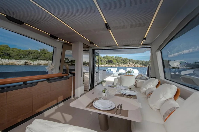  Yacht Photos Pics Luxurious interior of 2023 Azimut S7 yacht with elegant dining setup and scenic ocean view.