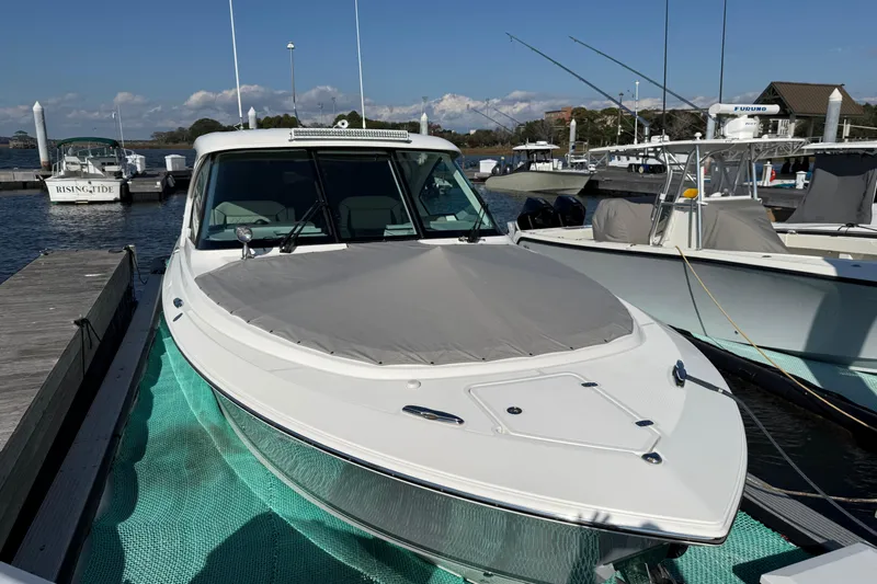  Yacht Photos Pics 2023 Pursuit DC 326 Dual Console boat docked at marina, front view.