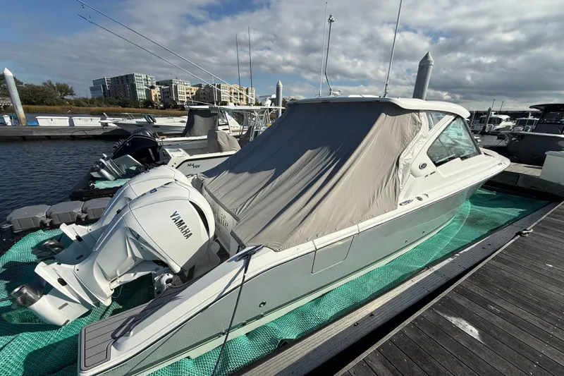  Yacht Photos Pics 2023 Pursuit DC 326 Dual Console boat docked with Yamaha engines, covered and ready for use.