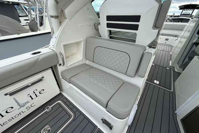  Yacht Photos Pics 2023 Pursuit DC 326 Dual Console boat interior with gray seating and sleek design.