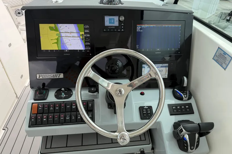  Yacht Photos Pics 2023 Pursuit DC 326 Dual Console boat dashboard with Garmin navigation displays and controls.