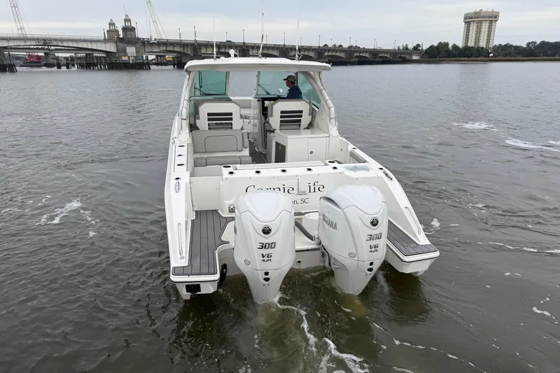  Yacht Photos Pics 2023 Pursuit DC 326 Dual Console boat with twin Yamaha 300 engines on a river.