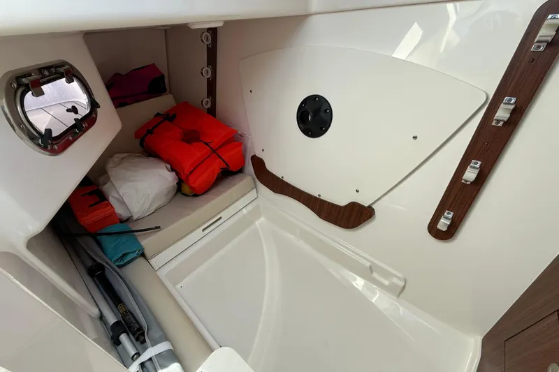  Yacht Photos Pics 2023 Pursuit DC 326 Dual Console interior storage with life jackets and equipment.