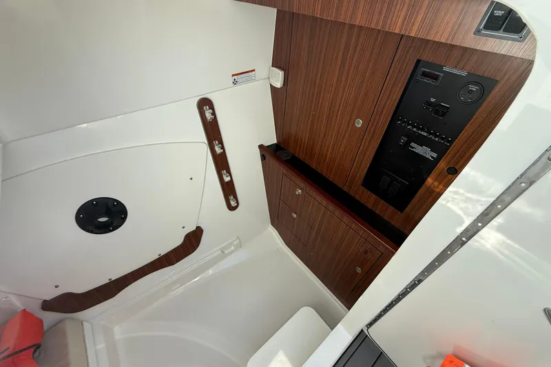  Yacht Photos Pics 2023 Pursuit DC 326 Dual Console interior with wood paneling and control panel.