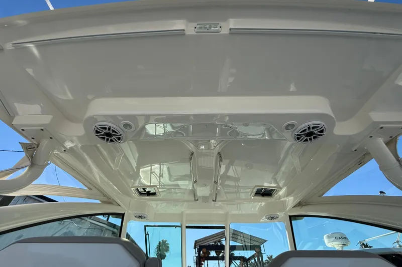  Yacht Photos Pics 2023 Pursuit DC 326 Dual Console boat interior with speakers and sleek design.