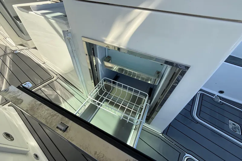  Yacht Photos Pics Open storage compartment on 2023 Pursuit DC 326 Dual Console boat deck.