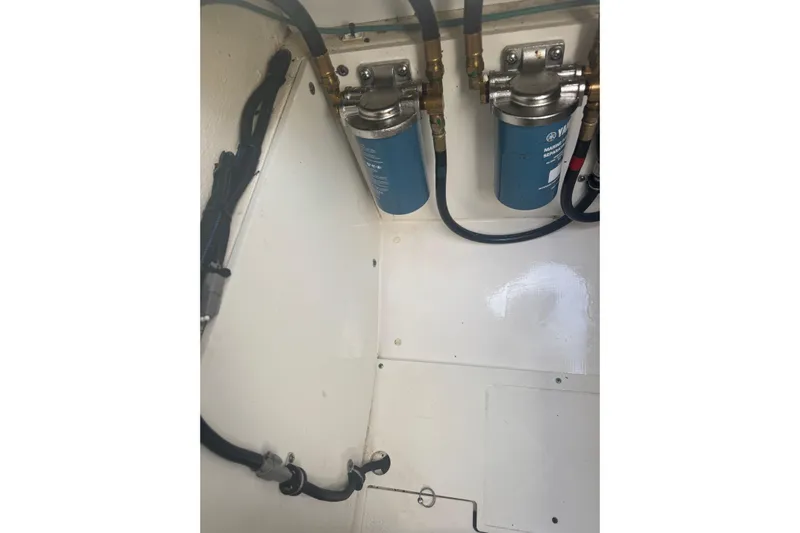  Yacht Photos Pics 2023 Pursuit DC 326 Dual Console engine compartment with fuel filters and hoses.