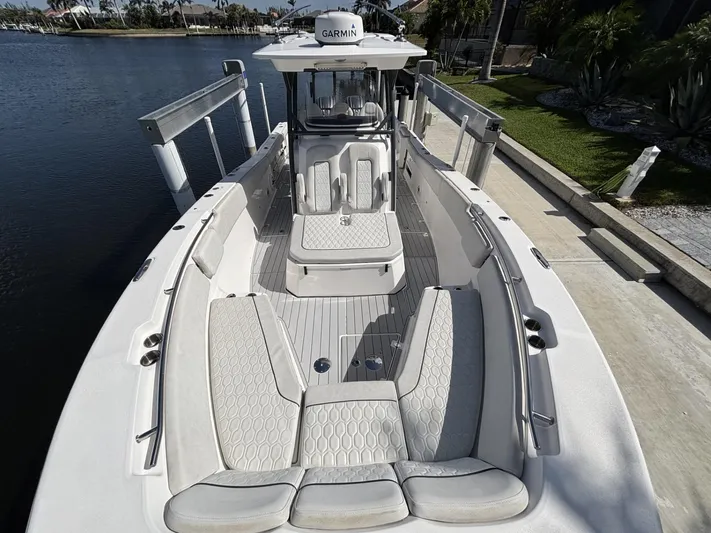  Yacht Photos Pics 2023 Sea Fox 328 Commander boat with spacious seating and modern design docked by the water.