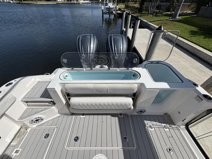  Yacht Photos Pics 2023 Sea Fox 328 Commander boat deck with seating and twin engines at a dock.