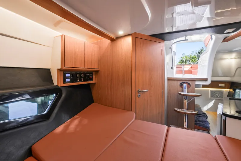  Yacht Photos Pics Luxurious interior of 2026 Hanover 355 yacht with modern wood finishes and comfortable seating.