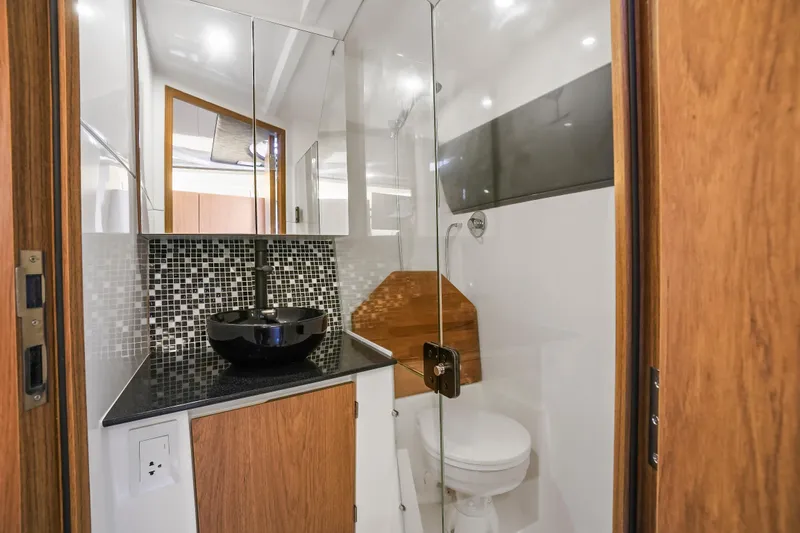  Yacht Photos Pics Modern bathroom in 2026 Hanover 355 RV with sleek design and glass shower.