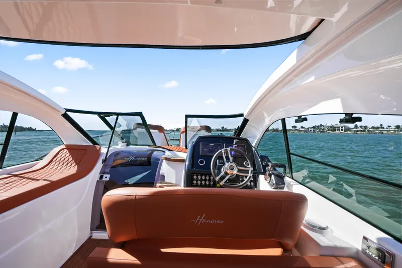  Yacht Photos Pics Interior view of 2026 Hanover 355 yacht with luxurious seating and modern dashboard.