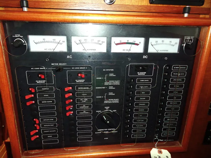 Azure Yacht Photos Pics Electrical control panel of a 2005 Pacific Seacraft 40 yacht, featuring AC and DC meters.
