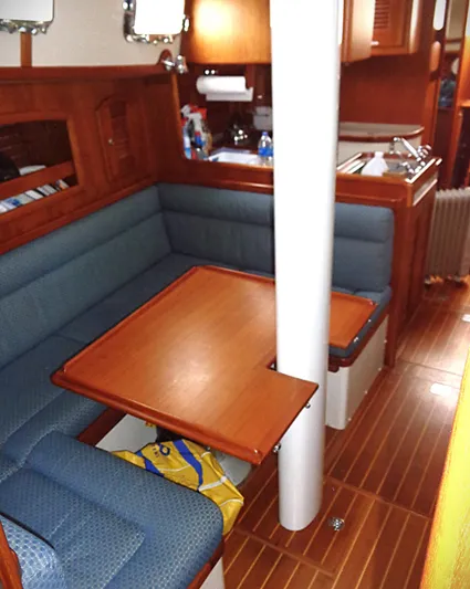 Azure Yacht Photos Pics Interior of 2005 Pacific Seacraft 40 sailboat with wooden dining area and blue seating.