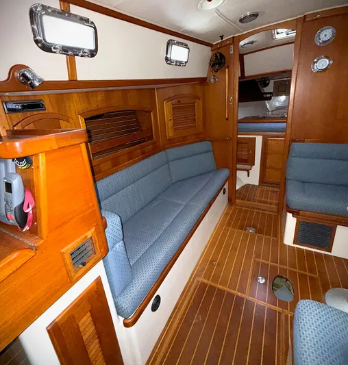 Azure Yacht Photos Pics Interior of 2005 Pacific Seacraft 40 sailboat with wooden finish and blue seating.