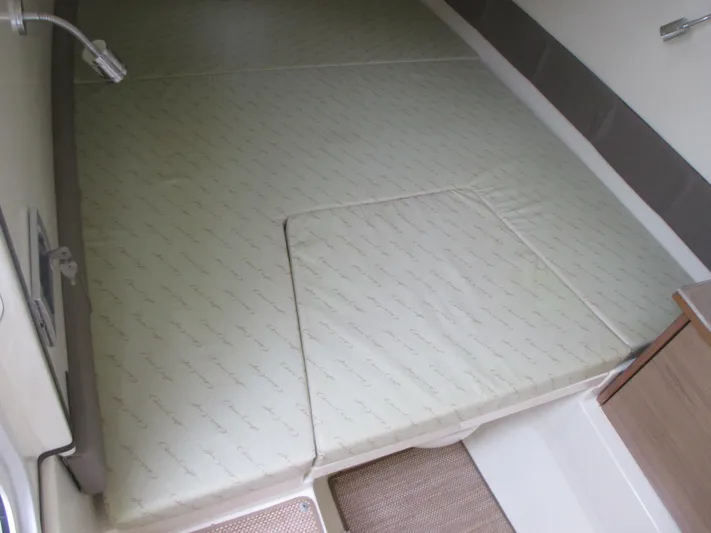  Yacht Photos Pics 2019 Chris-Craft Catalina 30 cabin interior with cushioned sleeping area.