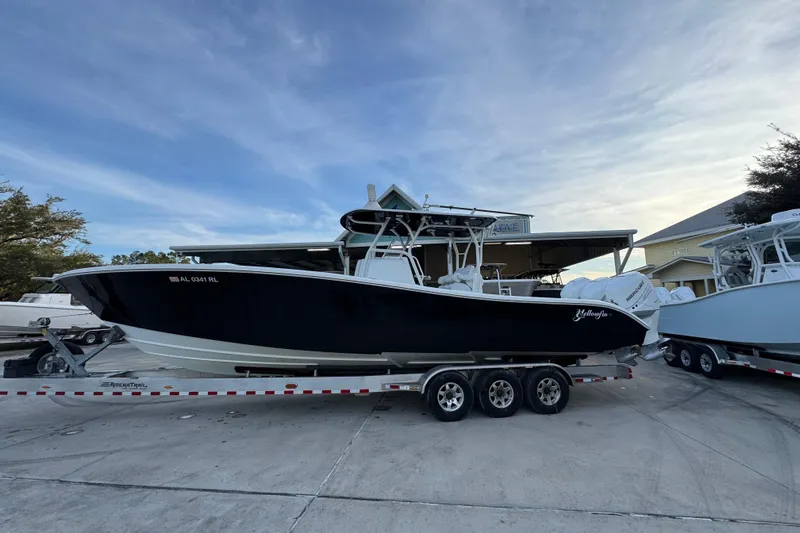  Yacht Photos Pics 2019 Yellowfin 34 Offshore boat on trailer, parked outdoors under a clear sky.