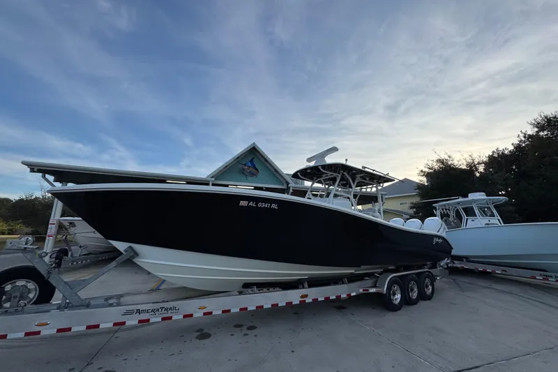  Yacht Photos Pics 2019 Yellowfin 34 Offshore boat on trailer, parked outdoors under a cloudy sky.