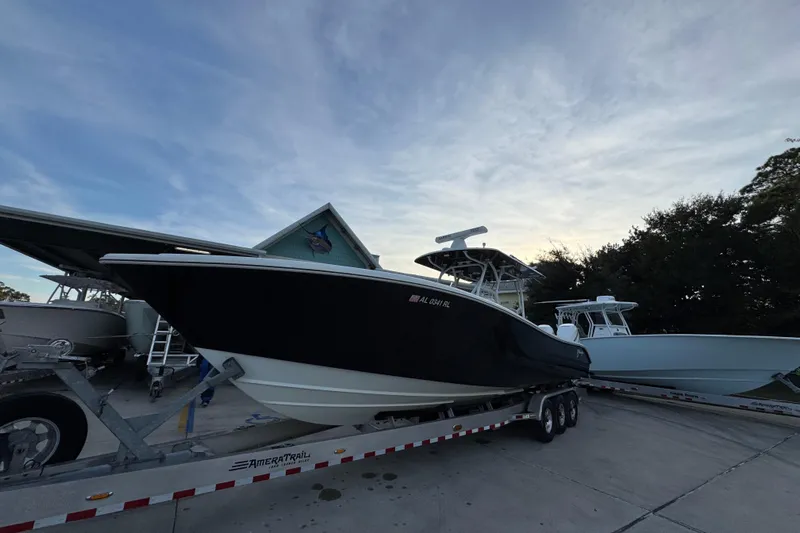  Yacht Photos Pics 2019 Yellowfin 34 Offshore boat on trailer, parked outdoors under a clear sky.