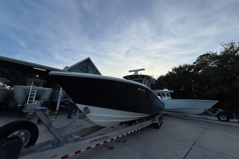  Yacht Photos Pics 2019 Yellowfin 34 Offshore boat on trailer at marina, evening sky backdrop.