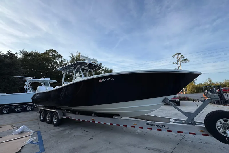  Yacht Photos Pics 2019 Yellowfin 34 Offshore boat on trailer, parked outdoors under a clear sky.