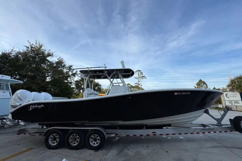  Yacht Photos Pics 2019 Yellowfin 34 Offshore boat on trailer, parked outdoors under a clear sky.