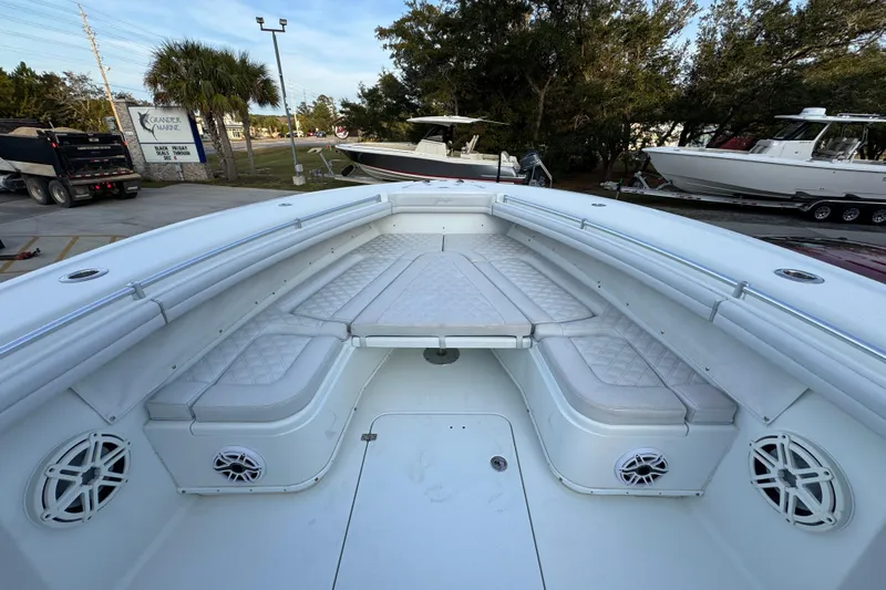  Yacht Photos Pics 2019 Yellowfin 34 Offshore boat interior with cushioned seating and speakers.
