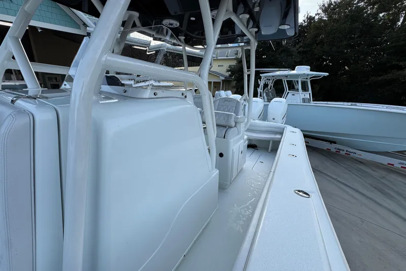  Yacht Photos Pics 2019 Yellowfin 34 Offshore boat interior with seating and console, docked outdoors.