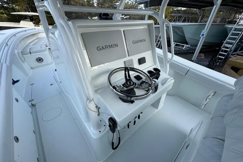  Yacht Photos Pics 2019 Yellowfin 34 Offshore boat cockpit with Garmin navigation system and steering wheel.