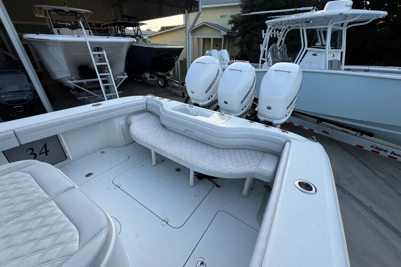  Yacht Photos Pics 2019 Yellowfin 34 Offshore boat with triple Mercury engines, docked in a marina.