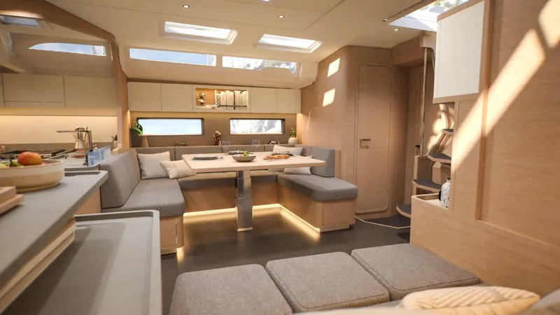  Yacht Photos Pics Luxurious interior of 2026 Dufour 54 yacht with modern seating and dining area.