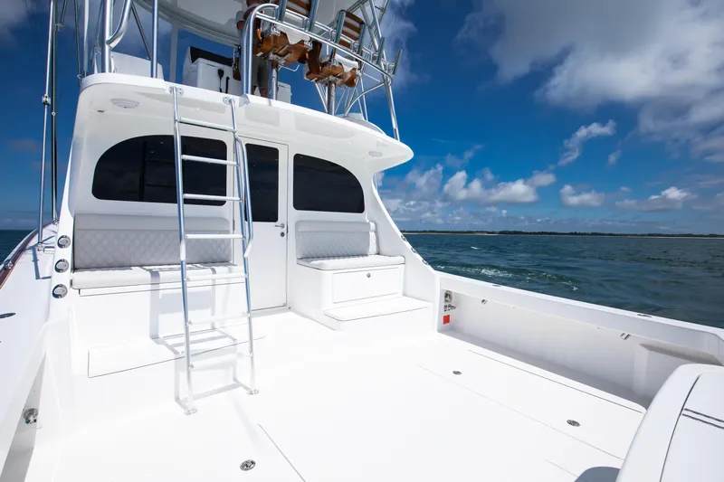 2026 46' Viking 46 Billfish Yacht Photos Pics 2026 Viking 46 Billfish yacht deck with ladder, ocean view, and clear blue sky.