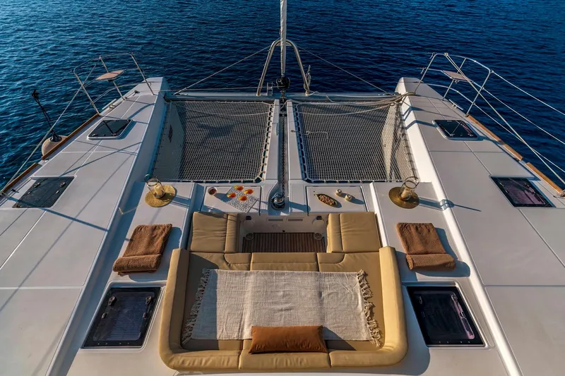  Yacht Photos Pics Luxurious 2018 Lagoon 52 F catamaran deck with seating, netting, and ocean view.
