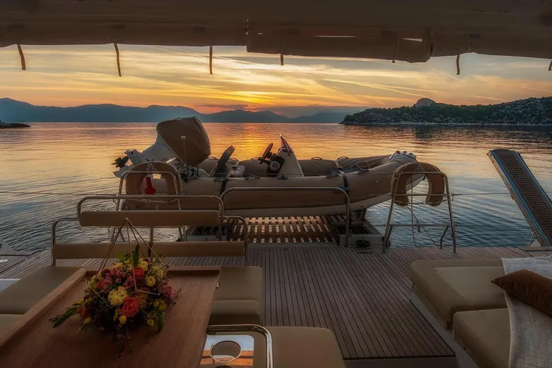 Yacht Photos Pics Luxurious Lagoon 52 F yacht deck at sunset, 2018 model, with scenic ocean view.