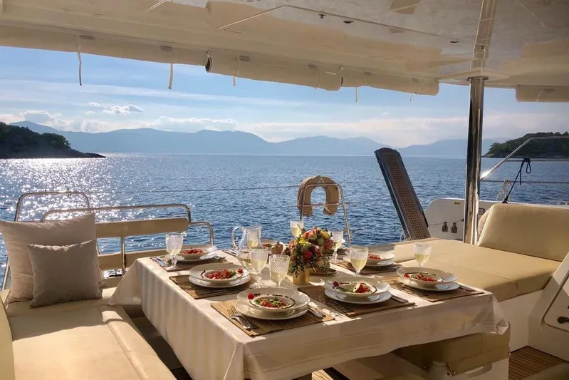 Yacht Photos Pics Luxurious dining setup on a 2018 Lagoon 52 F yacht with scenic ocean view.