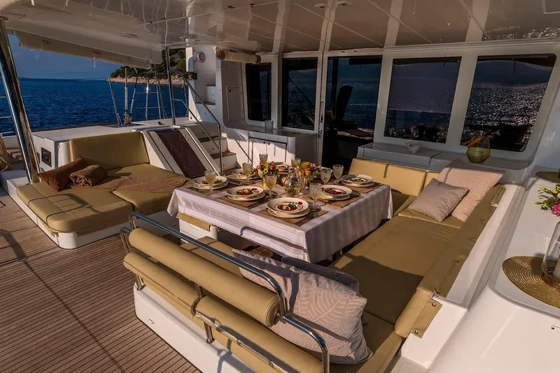  Yacht Photos Pics Luxurious 2018 Lagoon 52 F yacht with elegant outdoor dining setup at sea.