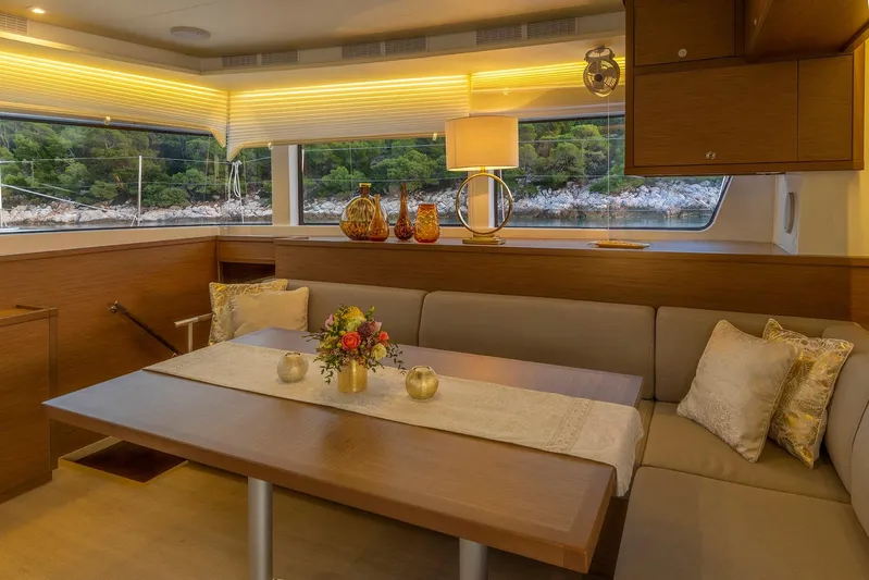  Yacht Photos Pics Luxurious interior of 2018 Lagoon 52 F yacht with elegant dining area and scenic window view.