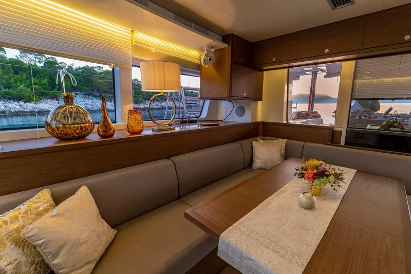  Yacht Photos Pics Luxurious interior of 2018 Lagoon 52 F yacht with elegant decor and scenic window view.