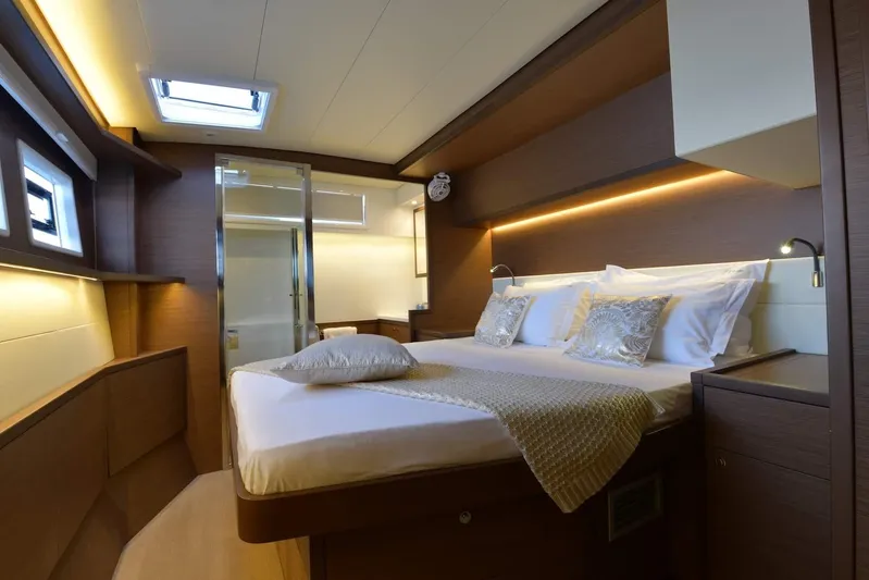  Yacht Photos Pics Luxurious cabin interior of 2018 Lagoon 52 F yacht with elegant bedding and ambient lighting.