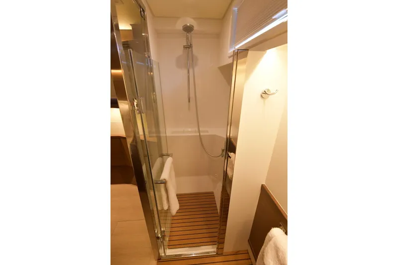  Yacht Photos Pics Luxurious shower in 2018 Lagoon 52 F yacht with glass door and wooden floor.