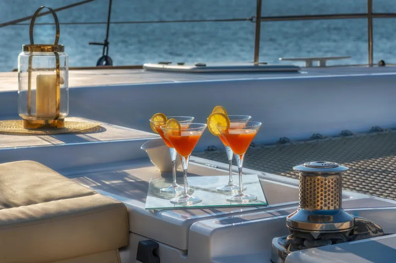  Yacht Photos Pics Cocktails on deck of 2018 Lagoon 52 F yacht, with ocean view and candle lantern.