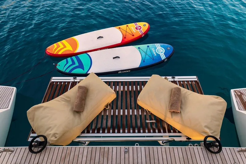  Yacht Photos Pics Two colorful paddleboards and loungers on Lagoon 52 F yacht deck, 2018 model.