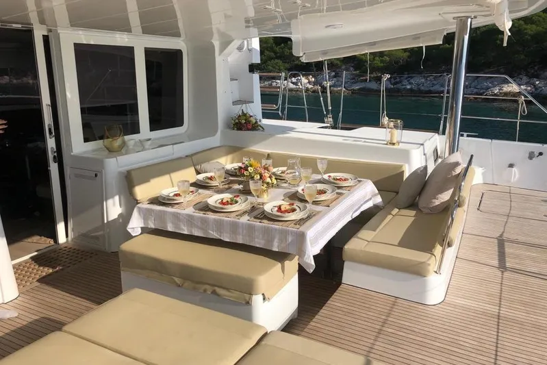  Yacht Photos Pics Luxurious dining setup on 2018 Lagoon 52 F yacht, featuring elegant tableware and scenic ocean view.