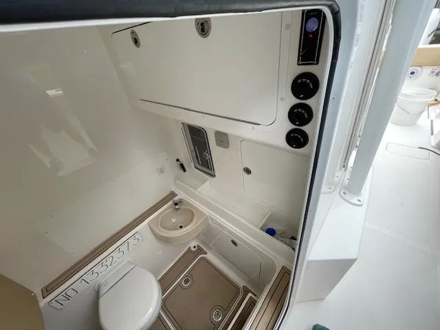  Yacht Photos Pics 2022 Invincible 36 Open Fisherman boat interior with compact bathroom amenities.