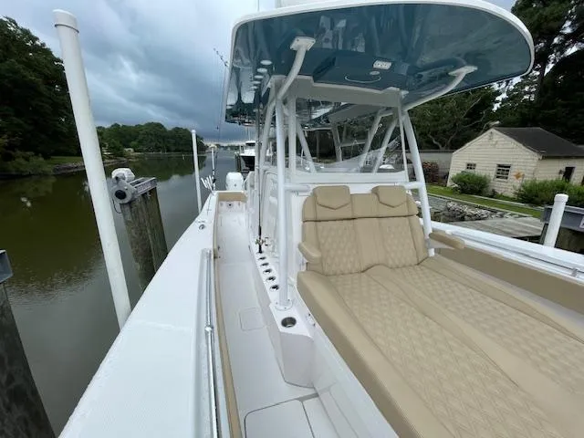  Yacht Photos Pics 2022 Invincible 36 Open Fisherman boat docked by a serene riverside.