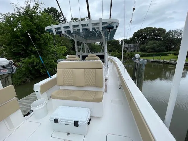  Yacht Photos Pics 2022 Invincible 36 Open Fisherman boat docked by a serene river.