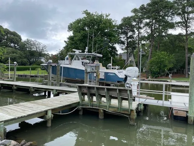  Yacht Photos Pics 2022 Invincible 36 Open Fisherman boat docked at a serene marina.